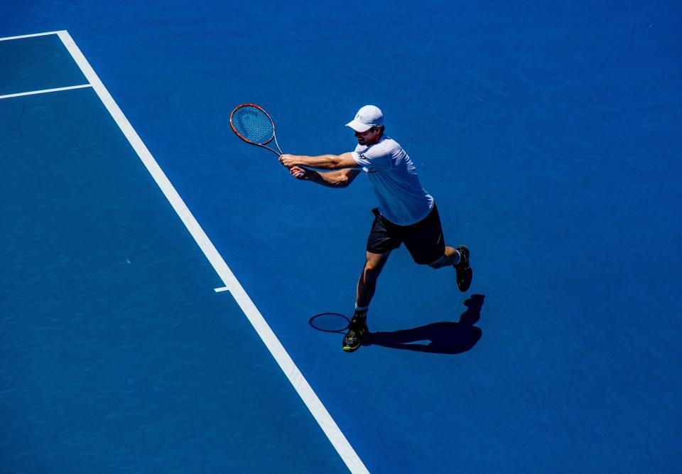 A player striking a backhand during a match